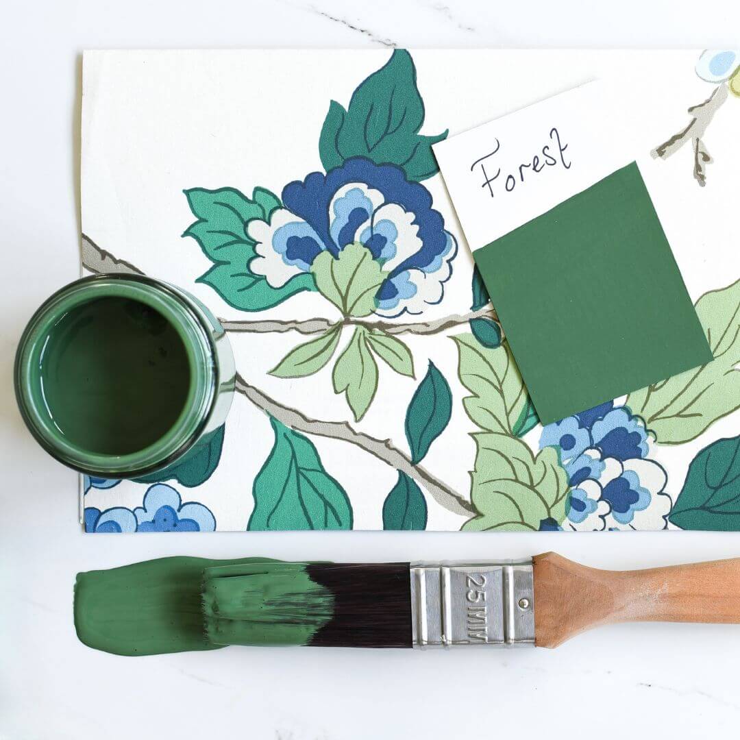 Fabric mood board with paint brush dipped in 120ml pot of Blake & Taylor Forest Chalk Furniture Paint
