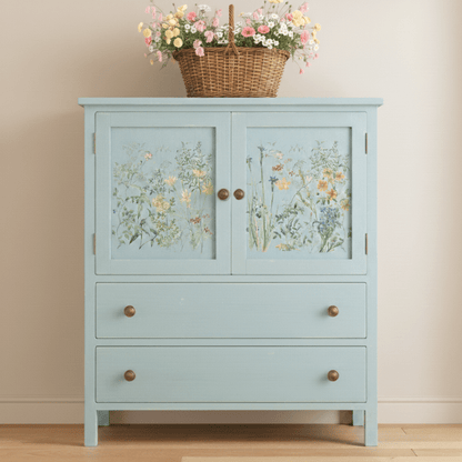 Light blue cabinet with floral designs on doors against a beige wall.