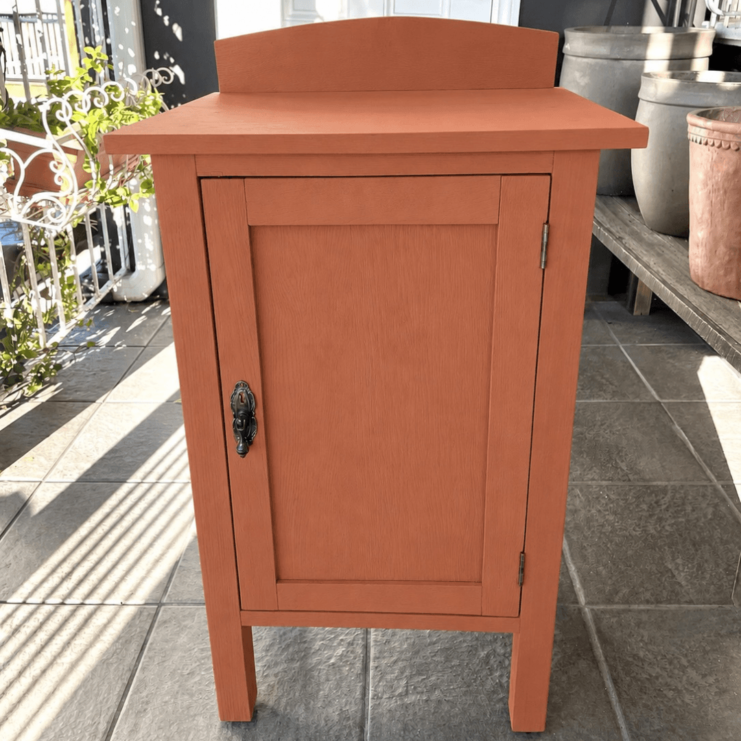 Wooden cabinet with a single door painted in colour Fox Den on a tiled floor
