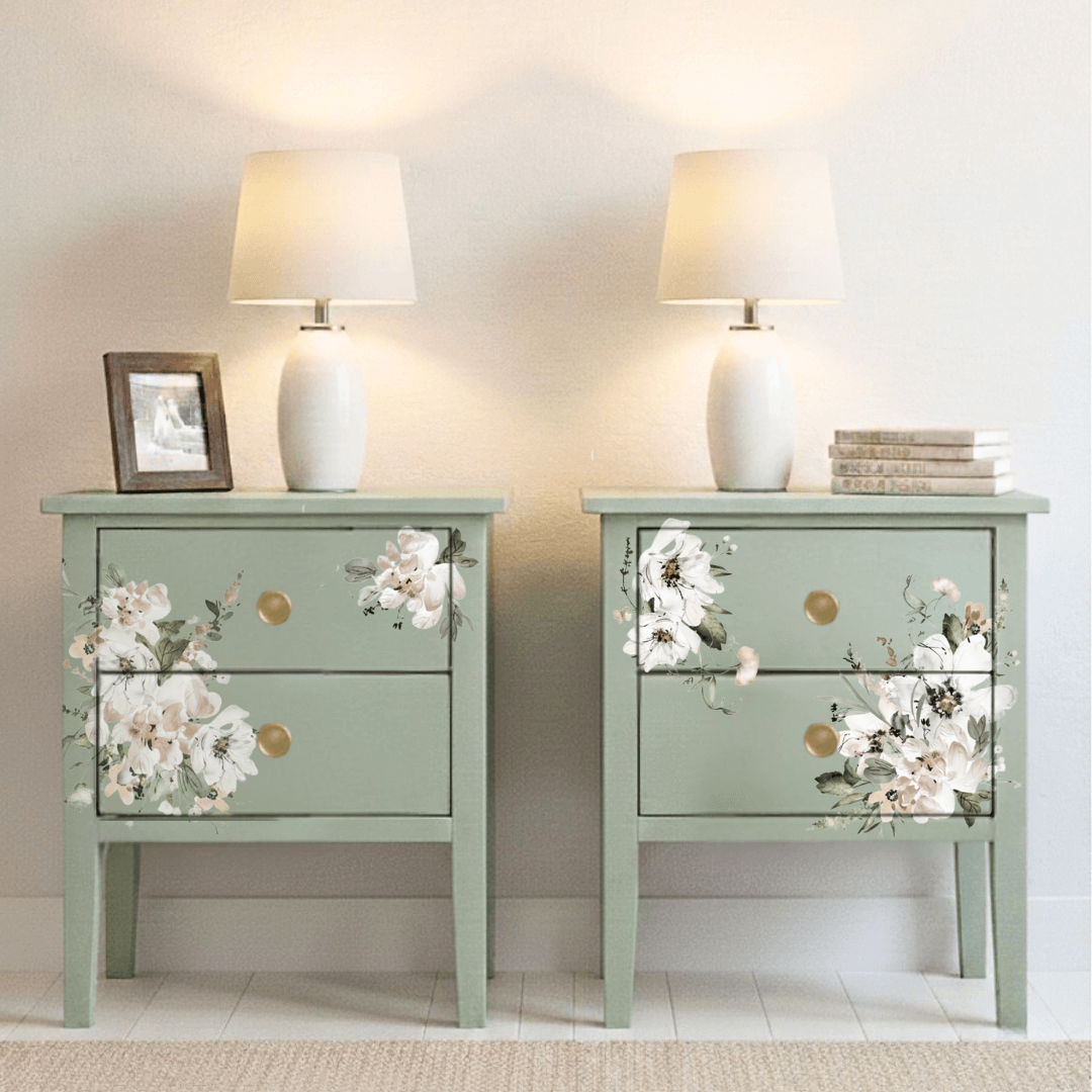 Two green nightstands with floral decors and lamps on a neutral background