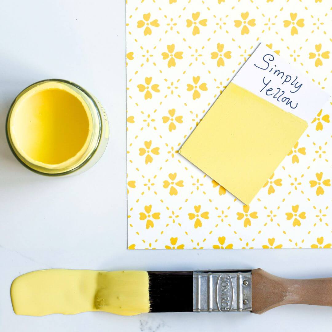 Yellow patterned wallpaper and brush dipped in 120ml pot of  Blake & Taylor Simply Yellow Chalk Furniture Paint